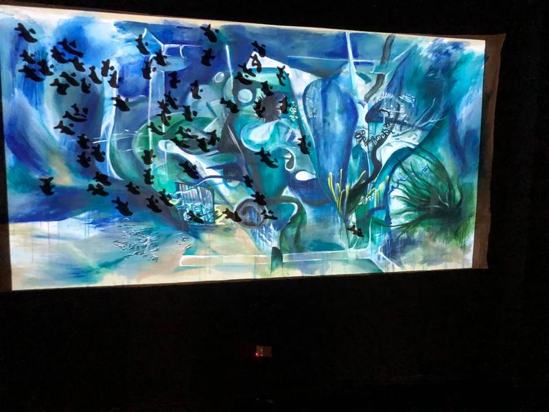 human/habitat A painting of abstract blues and green with small black shapes scattered across it.