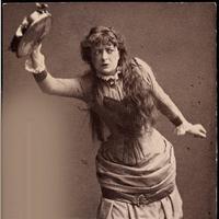 Adeleide Johannessen in character as Nora dancing the tarantella dance. Image from a cigarette card of c. 1880–82 via Wikimedia Monochrome image depicts Adeleide Johannessen in character as Nora dancing the tarantella dance and holding, above her head, a tambourine in her right hand.
