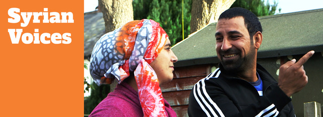 Syrian voices banner 2200x800px2 a man and woman talking in front of a house - shoulders only